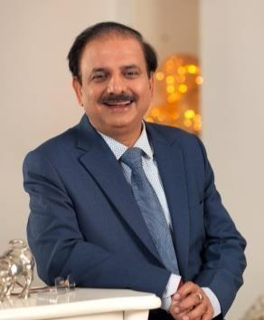 Dr. Rakesh Kumar in a blue suit